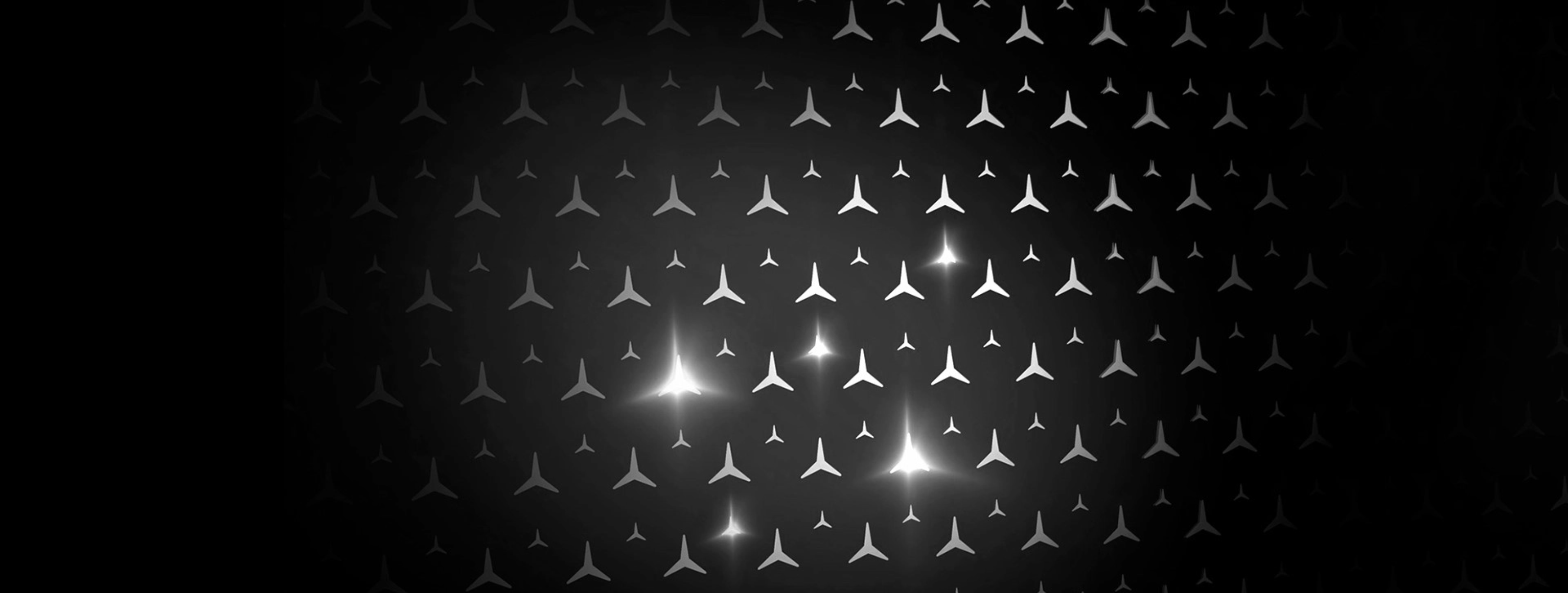 Glistering mercedes stars on a black background.